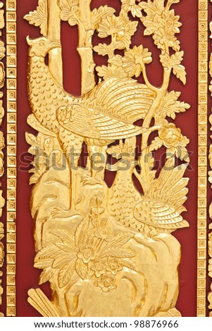 golden swan on red wood background