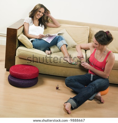 pictures in a living room of two young girls sitting on a couch