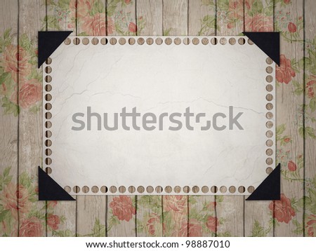 Notebook paper. Grunge page pasted to a wooden, floral background.