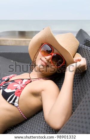 Young woman on deck chair