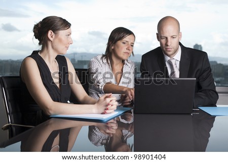 Group of office workers in a powerpoint presentation on laptop