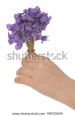 children hand with bouquet of violets for mother