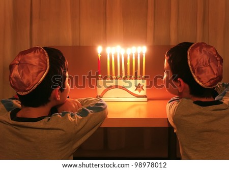 boys looking at hanukkah menorah