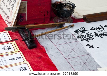 Calligraphy writing by a handicap woman in Asia.