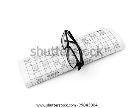Reading glasses sitting on a newspaper with a narrow depth of field