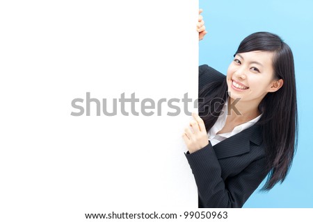 young woman holding blank billboard, isolated on blue background
