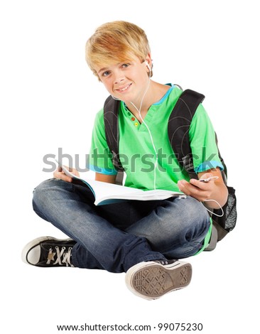 teen boy sitting on floor reading book isolated on white