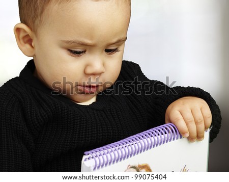 portrait of kid holding notebook indoor