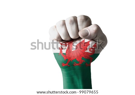 Low key picture of a fist painted in colors of wales flag