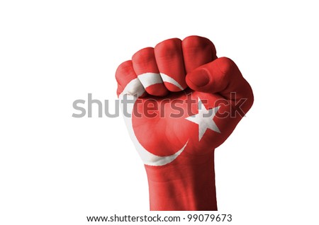 Low key picture of a fist painted in colors of turkey flag
