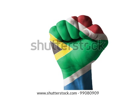 Low key picture of a fist painted in colors of south africa flag