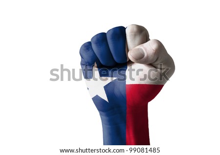 Low key picture of a fist painted in colors of american state flag of texas