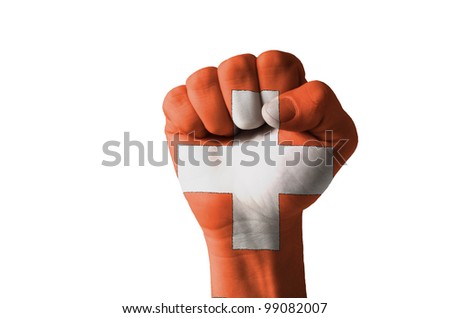 Low key picture of a fist painted in colors of schwitzerland flag