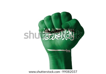 Low key picture of a fist painted in colors of saudi arabia flag