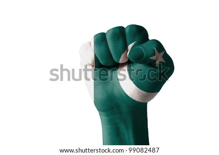 Low key picture of a fist painted in colors of pakistan flag