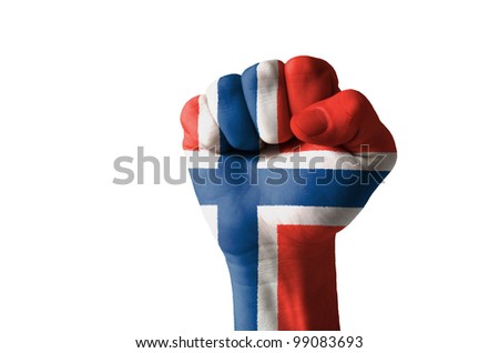 Low key picture of a fist painted in colors of norway flag