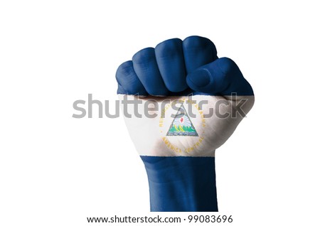 Low key picture of a fist painted in colors of nicaragua flag