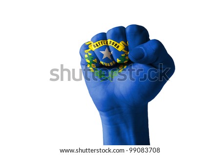 Low key picture of a fist painted in colors of american state flag of nevada