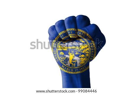 Low key picture of a fist painted in colors of american state flag of nebraska