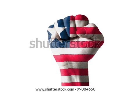Low key picture of a fist painted in colors of liberia flag