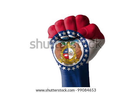 Low key picture of a fist painted in colors of american state flag of missouri