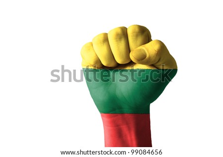 Low key picture of a fist painted in colors of lithuania flag