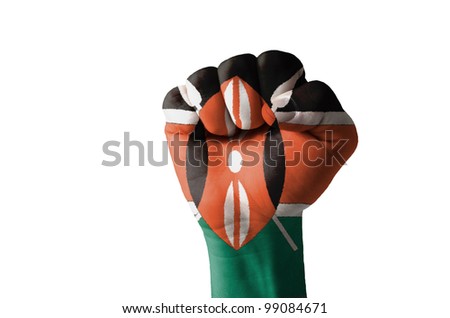 Low key picture of a fist painted in colors of kenya flag