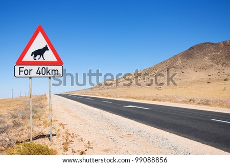 Warning of road sign - hyenas on the road with description "for 40 km" , Namibia