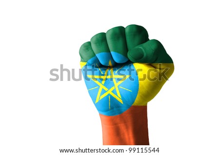 Low key picture of a fist painted in colors of ethiopia flag