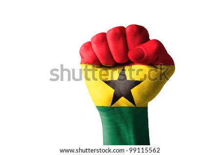 Low key picture of a fist painted in colors of ghana flag