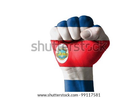 Low key picture of a fist painted in colors of costarica flag