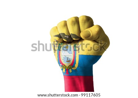 Low key picture of a fist painted in colors of ecuador flag