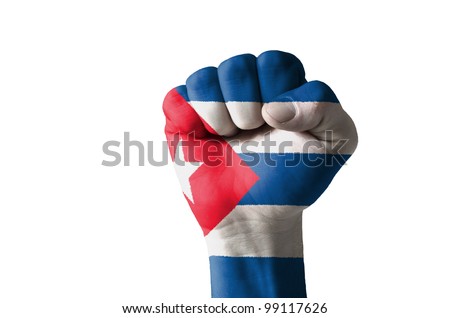 Low key picture of a fist painted in colors of cuba flag