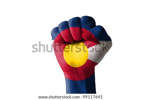 Low key picture of a fist painted in colors of american state flag of colorado