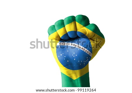 Low key picture of a fist painted in colors of brazil flag