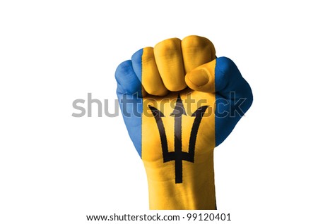 Low key picture of a fist painted in colors of barbados flag