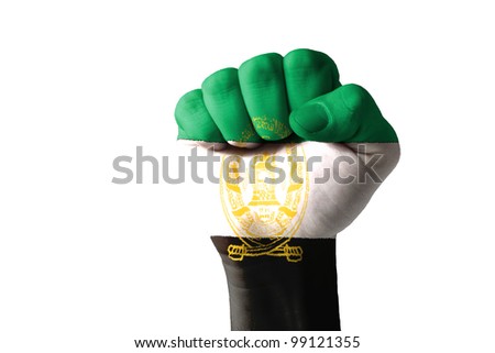 Low key picture of a fist painted in colors of afghanistan flag