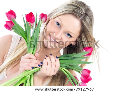 Beautiful blonde woman with red tulips bouquet of flowers smiling isolated on white background
