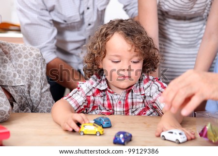 Boy playing with pram