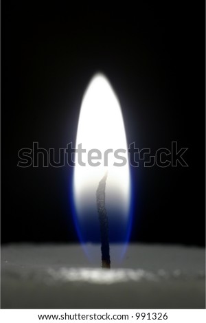A candle flame. Picture is in colour but quite desaturated, some yellow still in flame. Background is black, can be easily enlarged to make space for text.