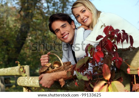 Couple with basket of mushrooms