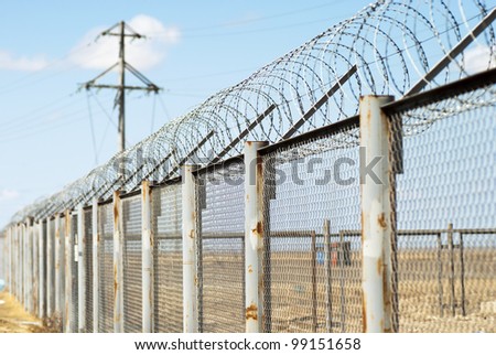 Fence with barbed wire (small depth of sharpness)
