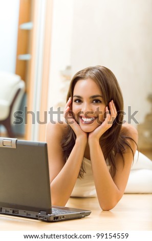 Young happy beautiful smiling woman working with laptop, at home