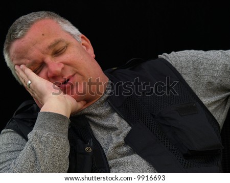 Sleeping or depressed man holding his head in his hand