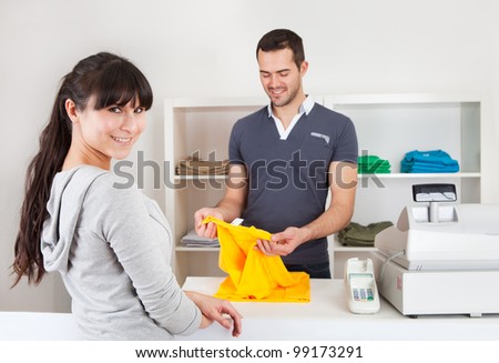 Female customer buying clothes at retail store