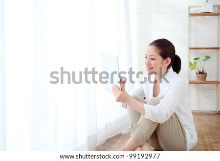 beautiful asian woman using tablet computer