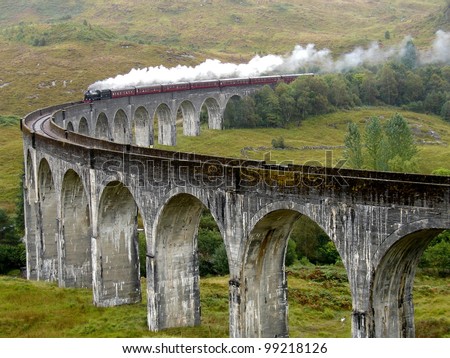 Steam train on Glenfinnan viaduct. Scotland. United Kingdom.  Royalty-Free Stock Photo #99218126
