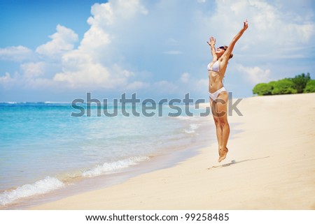 Vacation concept: happy woman on beach, summer in Bali