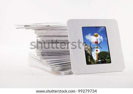 A pile of old slide photographs,with a photograph of chinese lanterns