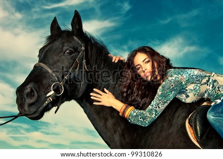 beautiful young woman on a horseback, outdoor portrait